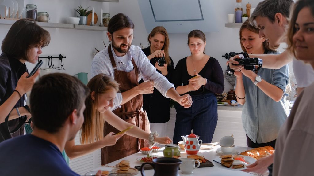 pexels-photo-9025071 People participating in a lively photoshoot around a table in a bright kitchen.